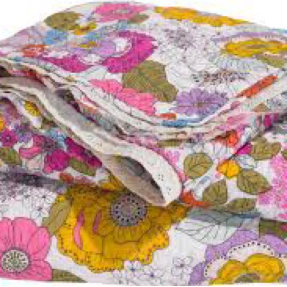 Cynthia Rowley quilted pillow sham with a multicolored boho floral pattern.